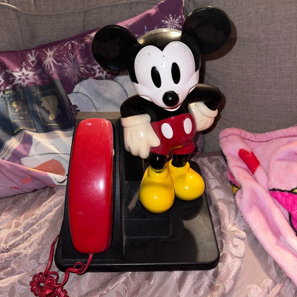 Mickey phone a little scratched and dinged up great for Disney collections .